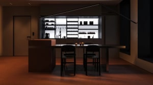 A modern minimalist residential kitchen with metallic cabinets, glass shelves, and wooden dining chairs.