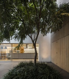 A modern minimalist urban retreat featuring a living room with concrete and steel materials.