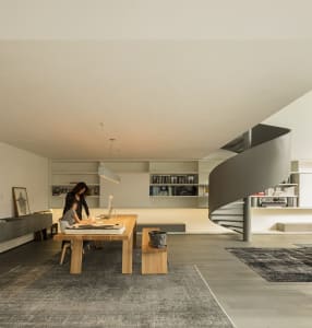 A minimalist office space featuring wooden furniture, designed for functionality and aesthetic simplicity.