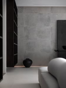 Modern living room with concrete wall and white sofa.