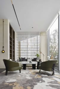 A modern living room featuring a metal grid wall and a cozy seating arrangement.