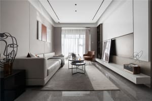 Modern neutral living room with minimalist design, featuring a contemporary sofa, coffee table, and accent chair, with a warm