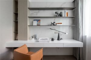 A sleek, minimalist home office with a modern design featuring a white marble desk and high-contrast black and white accents.