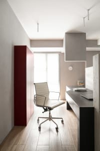 A modern office space featuring concrete and wood materials.
