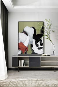 A modern minimalist living room with a black and white abstract painting, a black and white cabinet, and a green vase with le