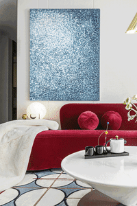 Modern living room featuring a red fabric sofa and a painted wall above it.