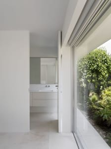 Modern minimalist bathroom with concrete walls and a clean, uncluttered design.