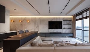 Modern living room featuring a marble accent wall and contemporary furniture.
