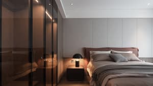Minimalist bedroom design featuring a bed with textured fabric bedding, a sleek nightstand lamp, and minimalist decor.