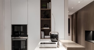 A modern kitchen interior with white marble countertops.