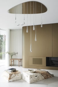 Modern minimalist living room featuring a stylish marble coffee table and abstract block accents.