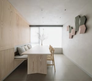A modern interior design space featuring wooden furniture and a minimalist aesthetic.