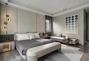 A modern bedroom featuring a concrete bed frame, leather headboard, and metal accents.