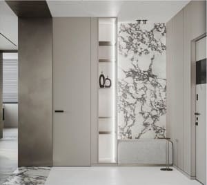 Modern entryway featuring white marble tiles and a shelf with black vases.
