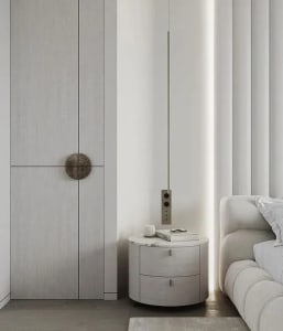 Modern minimalist bedroom featuring white materials, including a sleek round nightstand, a white sofa, and a large window wit