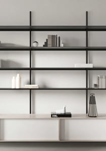 A minimalist metal shelf with books and decorative objects.