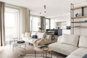 Modern living room with neutral-toned furniture and decor, natural light, and open floor plan.