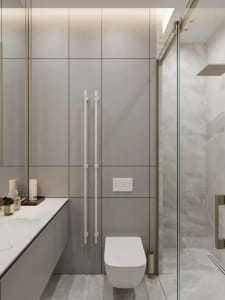 A modern bathroom featuring minimalist design with white tiles and glass shower enclosure.