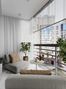 A modern living room featuring grey fabric furniture, white curtains, and potted plants.