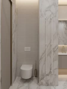 Modern minimalist bathroom with marble walls and floor, featuring a white toilet and a sleek faucet.