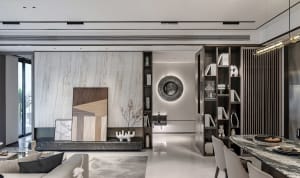A modern interior space featuring a marble wall and floor, with a minimalist design.