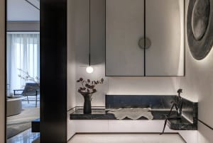 A modern lounge area with marble, concrete, and leather materials, featuring a minimalist design with a sleek, sophisticated 