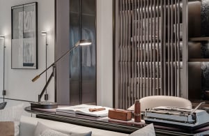 A modern office setting with a sleek metal desk, a comfortable seating area, and essential work tools.