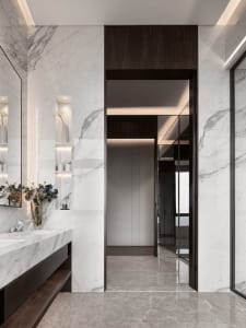 Modern bathroom featuring marble walls and flooring, minimalist design, and sleek fixtures.