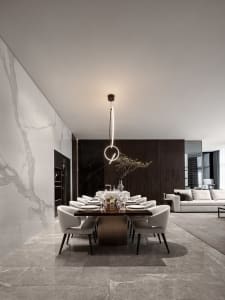 Modern dining room with marble table and chairs, minimalist decor, and sleek design.