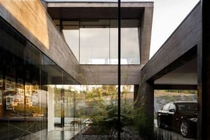 A modern house with concrete walls and a glass facade.