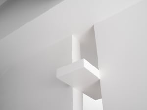 Minimalist modern interior space featuring exposed concrete walls and ceiling.