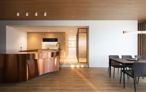 A modern kitchen with wooden panels and a sleek, minimalist design.