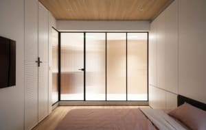 Modern bedroom featuring a window with a view of terrazzo flooring.