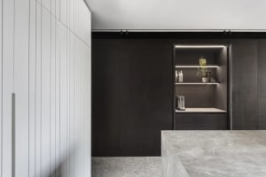 Modern residential kitchen featuring stone and metal materials.