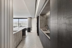 Modern kitchen with industrial design features, showcasing sleek marble countertops and minimalist aesthetic.