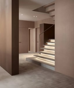 A minimalist interior design featuring wooden, concrete, and metallic elements.