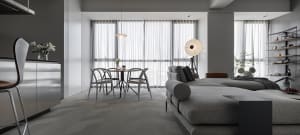 Contemporary living room with gray fabric sofa and dining area by the window.