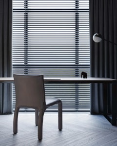Modern home office featuring a wooden desk and chair with a minimalist design aesthetic.