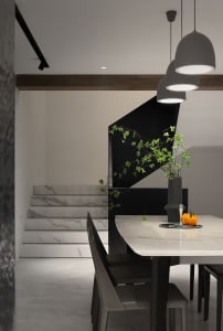 Modern residential staircase featuring marble steps and black wooden railing.