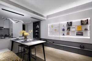 Modern, minimalist living room with sleek, white furniture and open shelving.