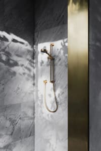 Modern minimalist bathroom with marble shower head.