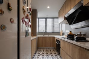 Modern minimalist kitchen featuring wooden cabinets and a white countertop with a patterned floor.
