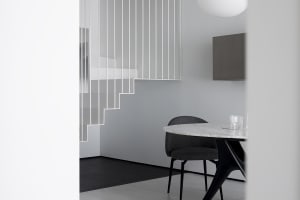 A minimalist interior featuring marble stairs and furniture.