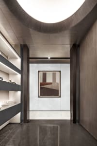 Modern interior design featuring a sleek corridor with marble flooring and wooden walls.