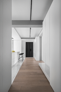Modern white corridor interior with minimalistic design and wooden flooring.