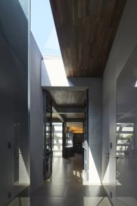 A modern interior design featuring a concrete ceiling and a large window