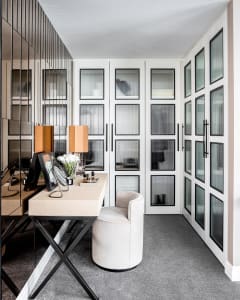 A modern office space featuring a white desk, steel details, and minimalist design.
