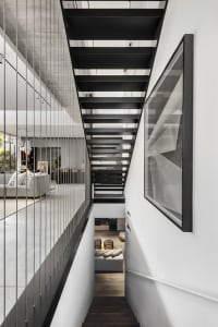 A modern residential staircase featuring black metal treads and railings.