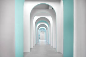 Modern architectural interior designed with white and blue accents, showcasing contemporary design elements.