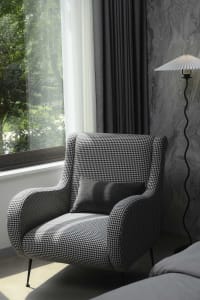 A modern living room featuring a black and white checkerboard armchair.